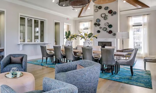 room with table chairs and recliners