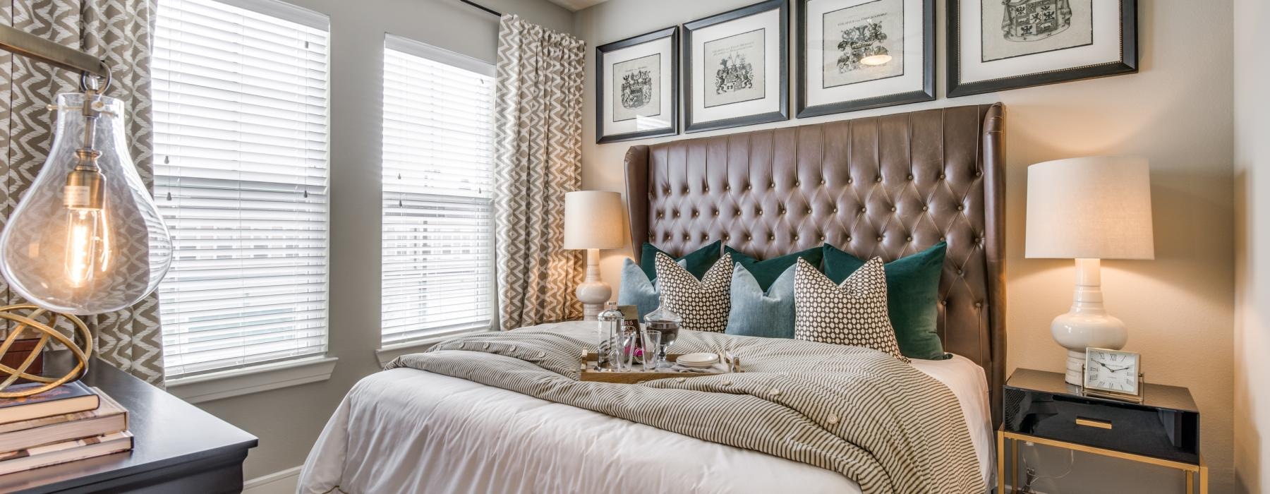 a bedroom with a bed and lamps