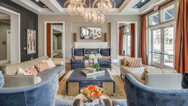 Clubroom with plush furniture, elegant decor, and large windows with bright natural light.